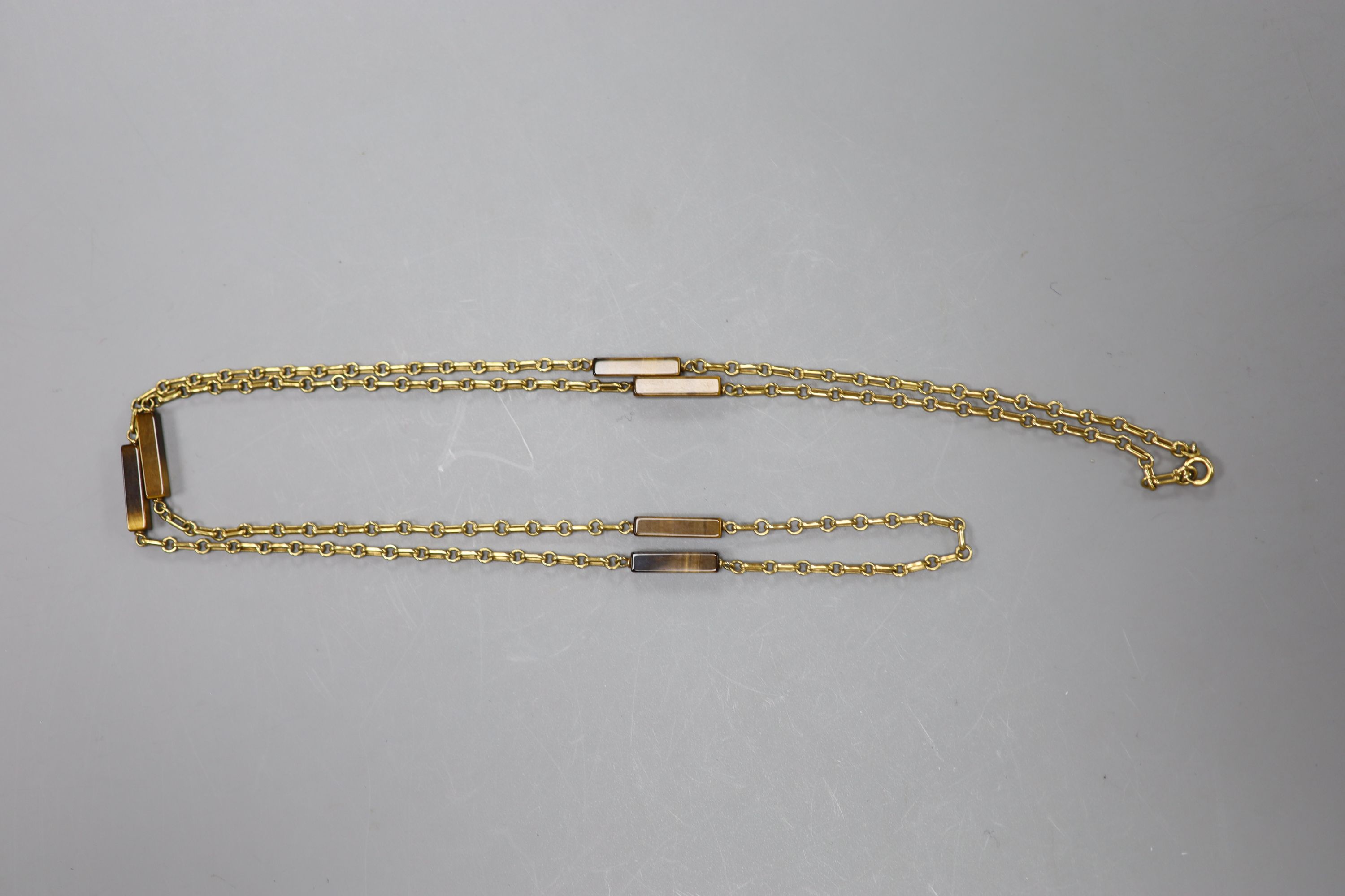 A modern 9ct gold and rectangular tiger's eye quartz baton link necklace, 79cm